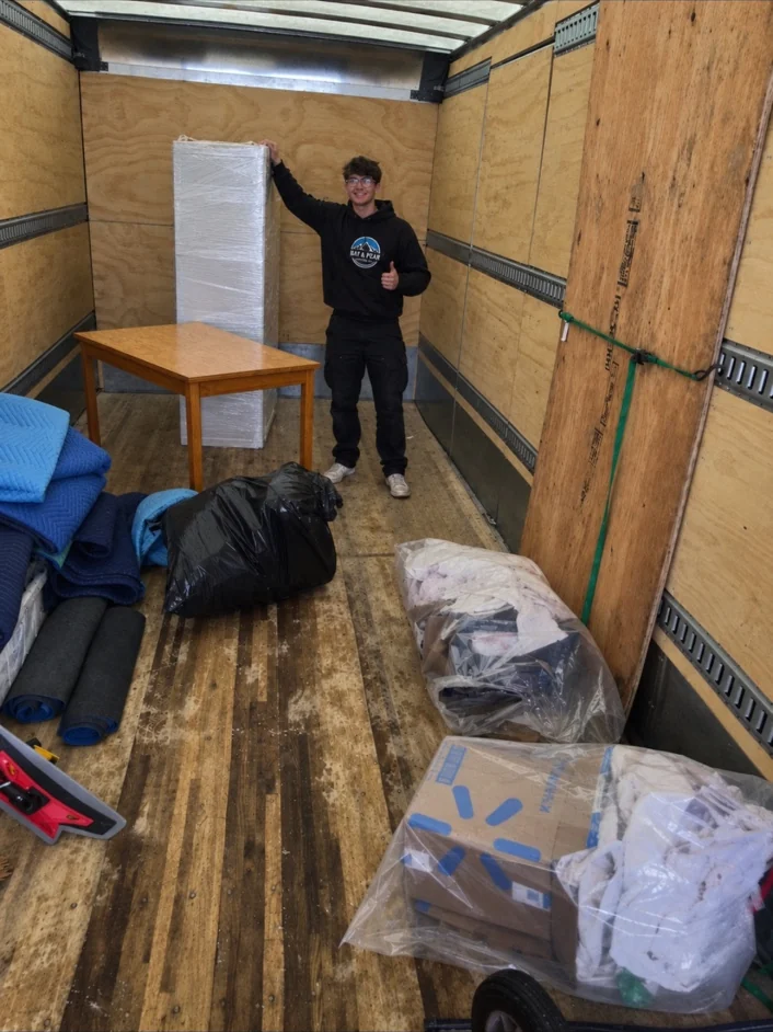 Bay & Peak crew member inside a moving truck