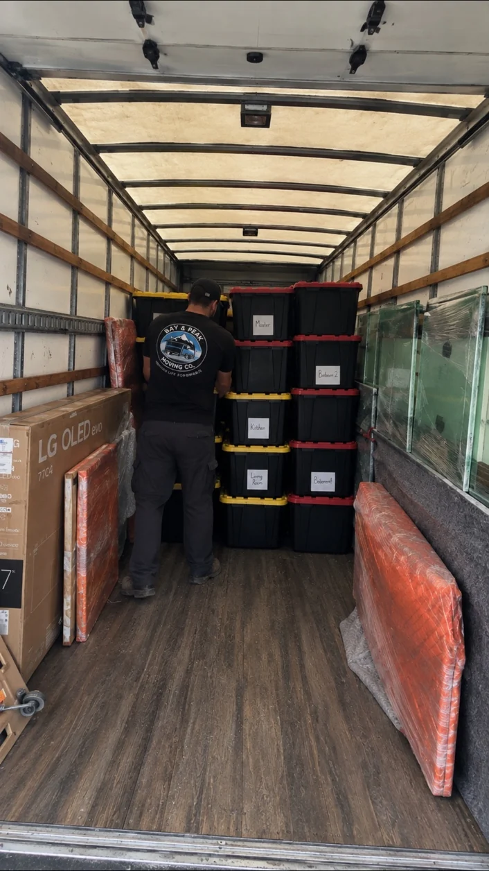 Bay & Peak mover organizing a loaded moving truck