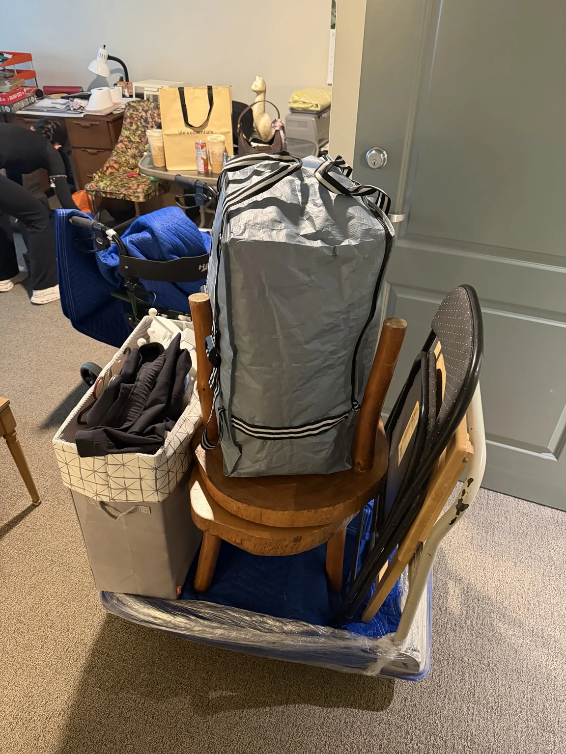 Furniture and clothing organized on a moving cart
