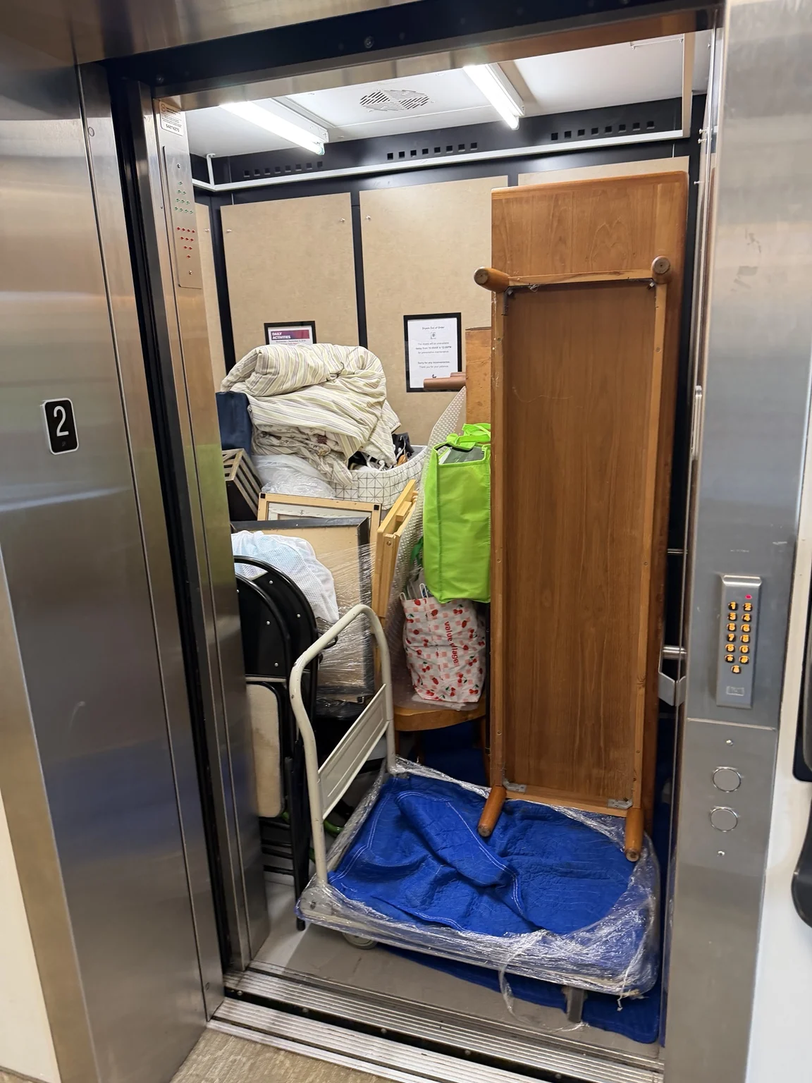 Furniture and household items carefully staged in an elevator