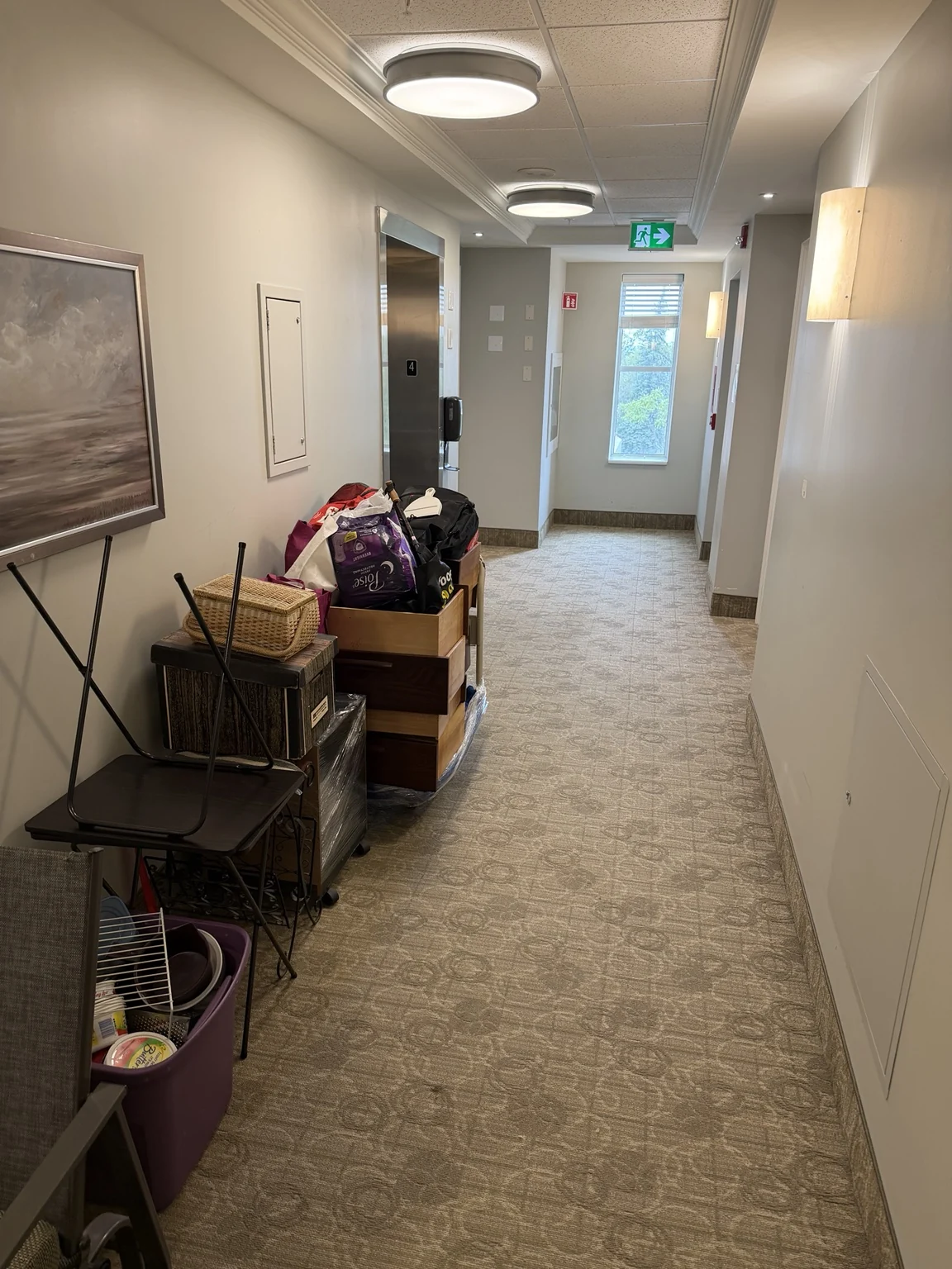 Household items staged neatly in a condo hallway