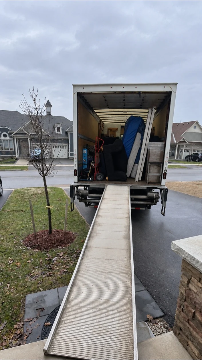 Moving truck positioned at a home with ramp ready